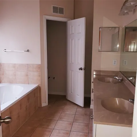 a spacious bathroom with a granite countertop sink a toilet and shower