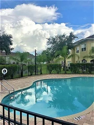 a view of a swimming pool with a patio