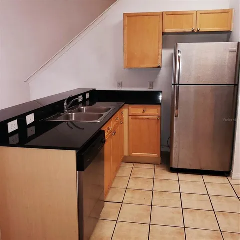 a kitchen with a stove a refrigerator and a sink