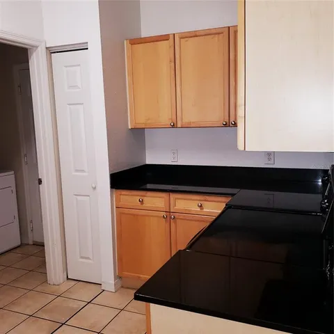 a kitchen with a refrigerator and cabinets