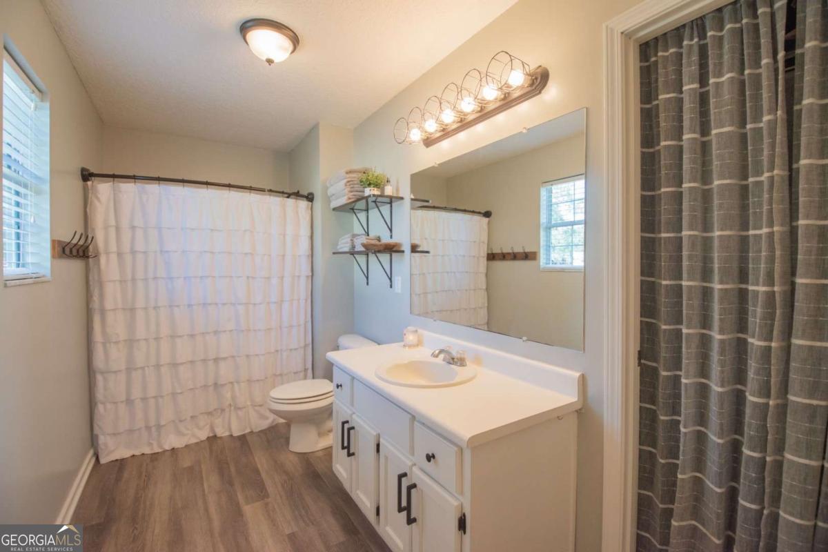 564 Dallas Circle Folkston, GA 31537 - Photo 16 of 21 a bathroom with a sink a toilet and shower