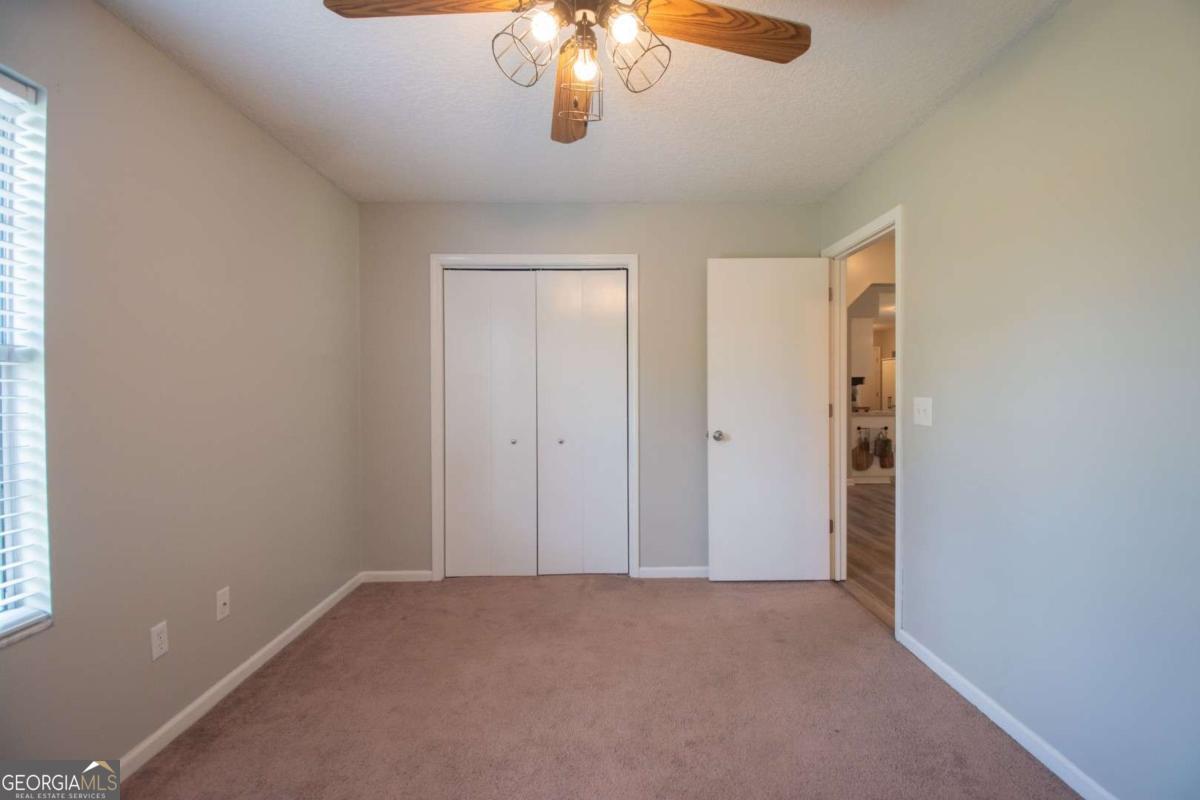 564 Dallas Circle Folkston, GA 31537 - Photo 19 of 21 a view of an empty room with a chandelier fan