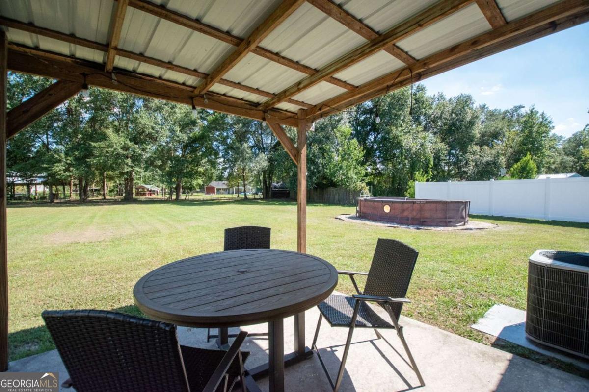 564 Dallas Circle Folkston, GA 31537 - Photo 5 of 21 a view of a table and chairs in patio
