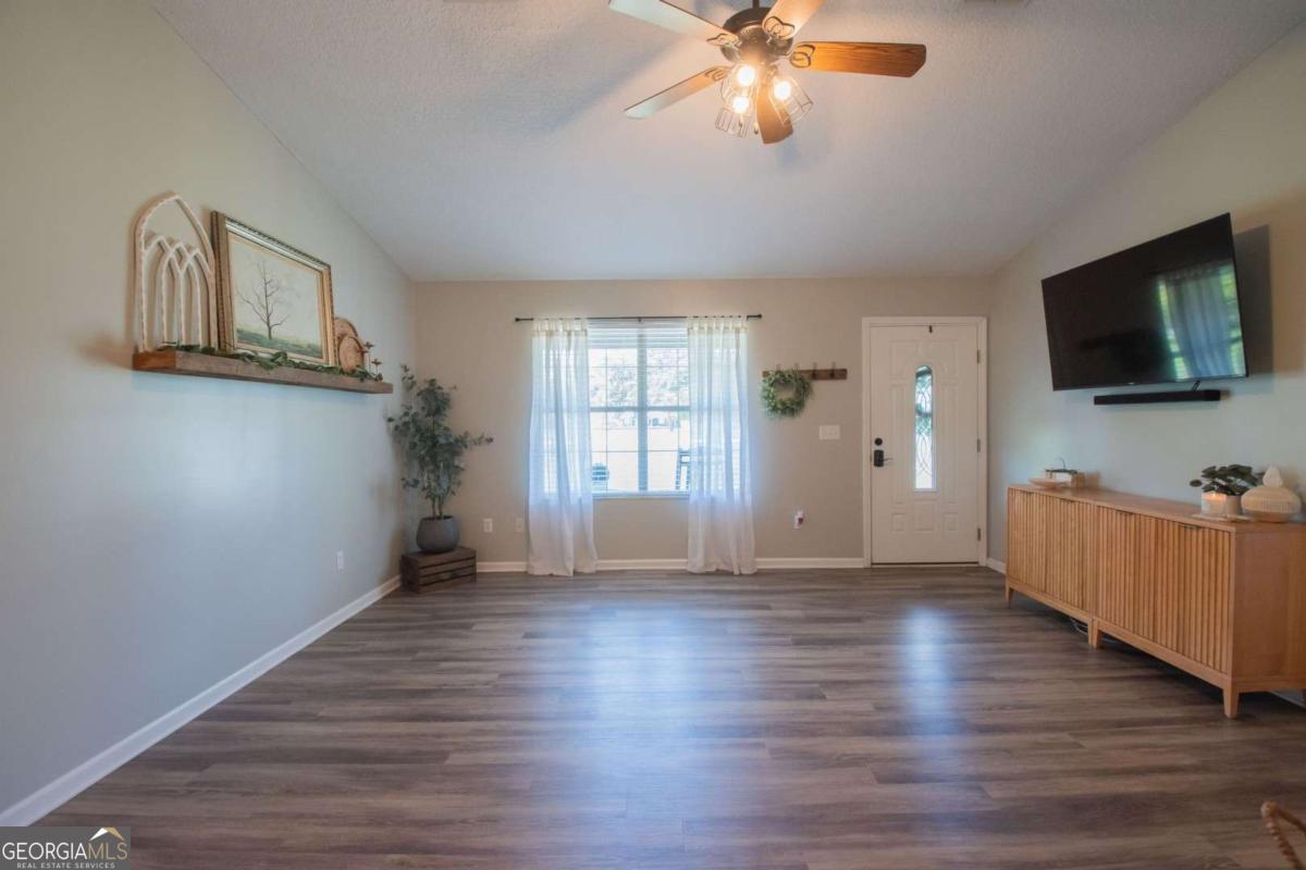 564 Dallas Circle Folkston, GA 31537 - Photo 7 of 21 a view of a livingroom with wooden floor and a window