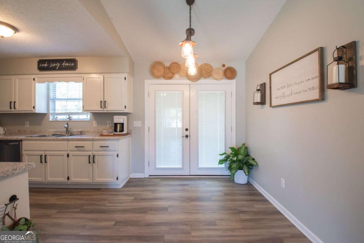 564 Dallas Circle Folkston, GA 31537 - Photo 9 of 21 a kitchen with granite countertop a stove a sink and a refrigerator