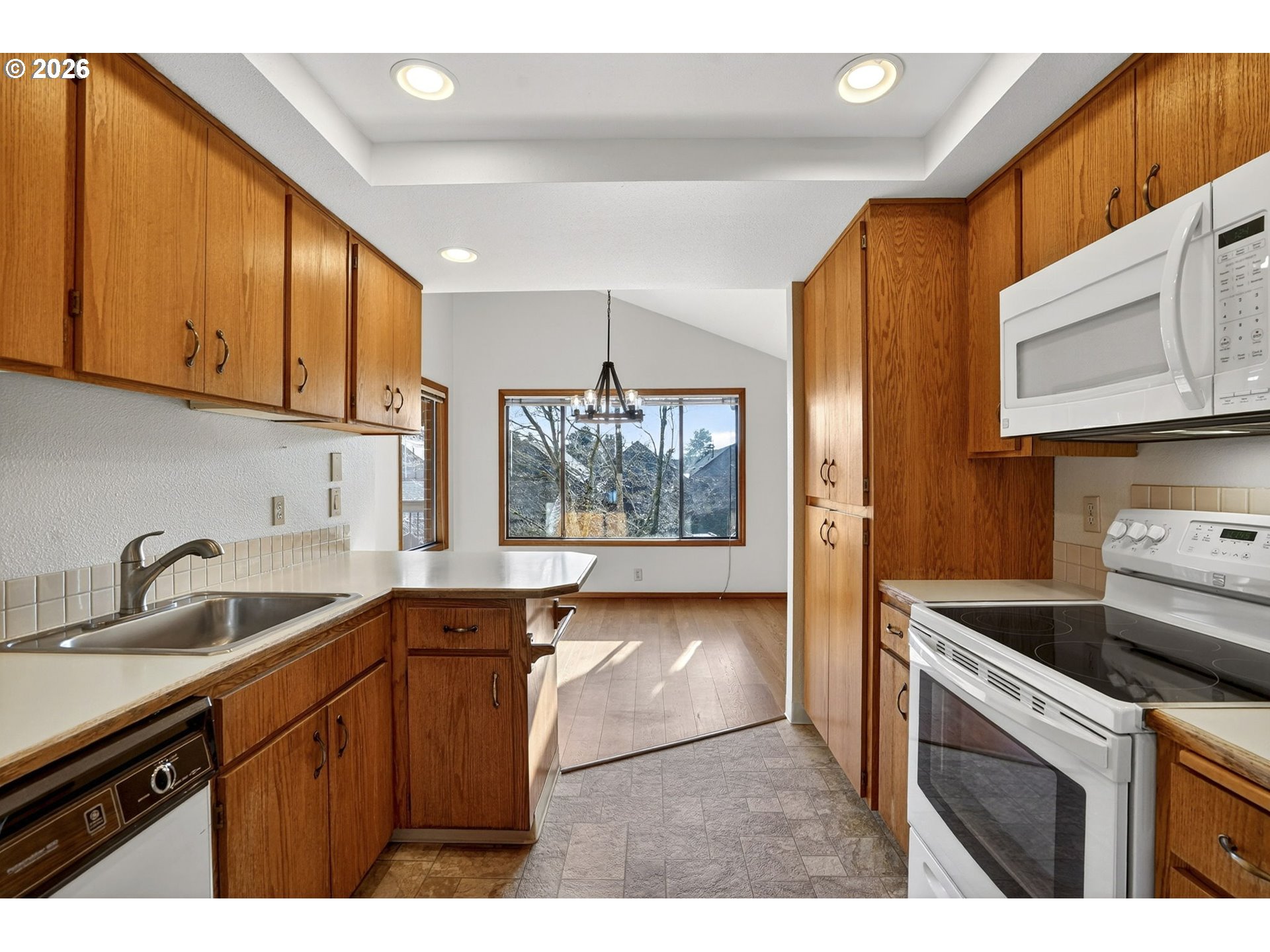 15485 Southwest 114th Court, Unit 39 Portland, OR 97224 - Photo 11 of 32 a kitchen with a sink cabinets and window