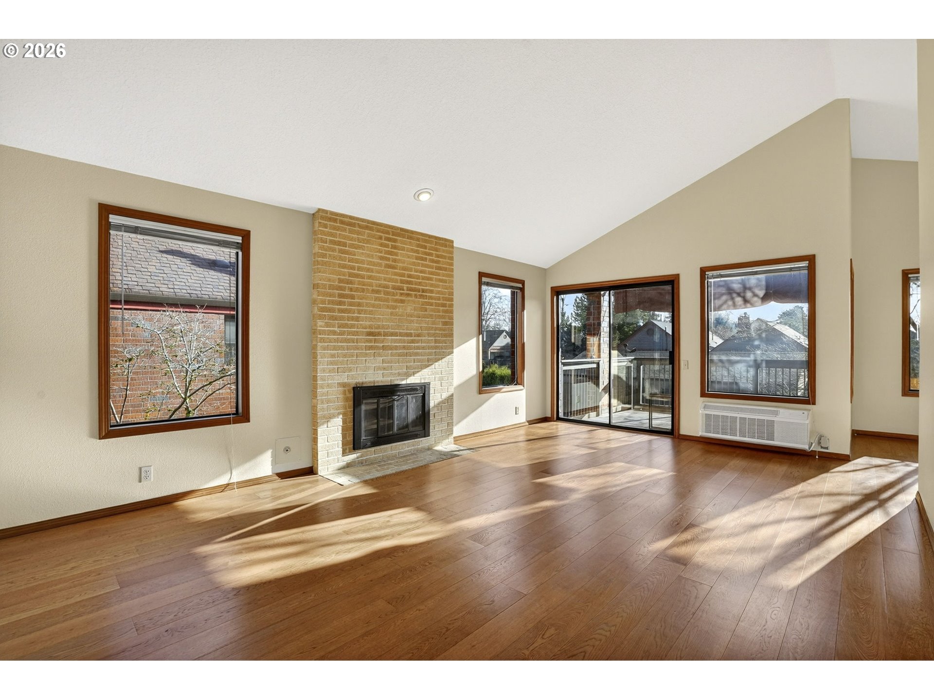 15485 Southwest 114th Court, Unit 39 Portland, OR 97224 - Photo 4 of 32 a view of an empty room with a fireplace and a window