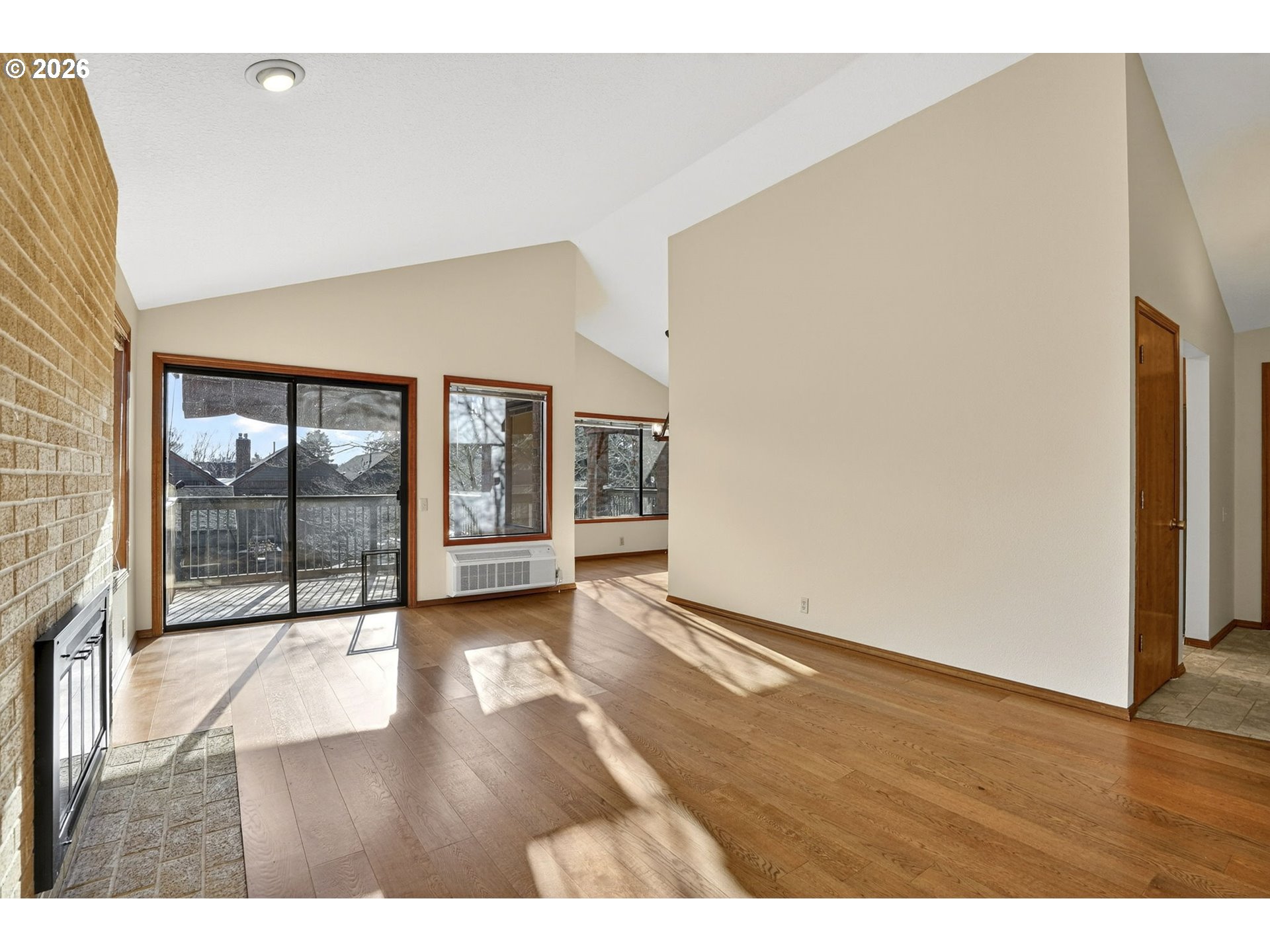 15485 Southwest 114th Court, Unit 39 Portland, OR 97224 - Photo 5 of 32 a view of an empty room with wooden floor and a window