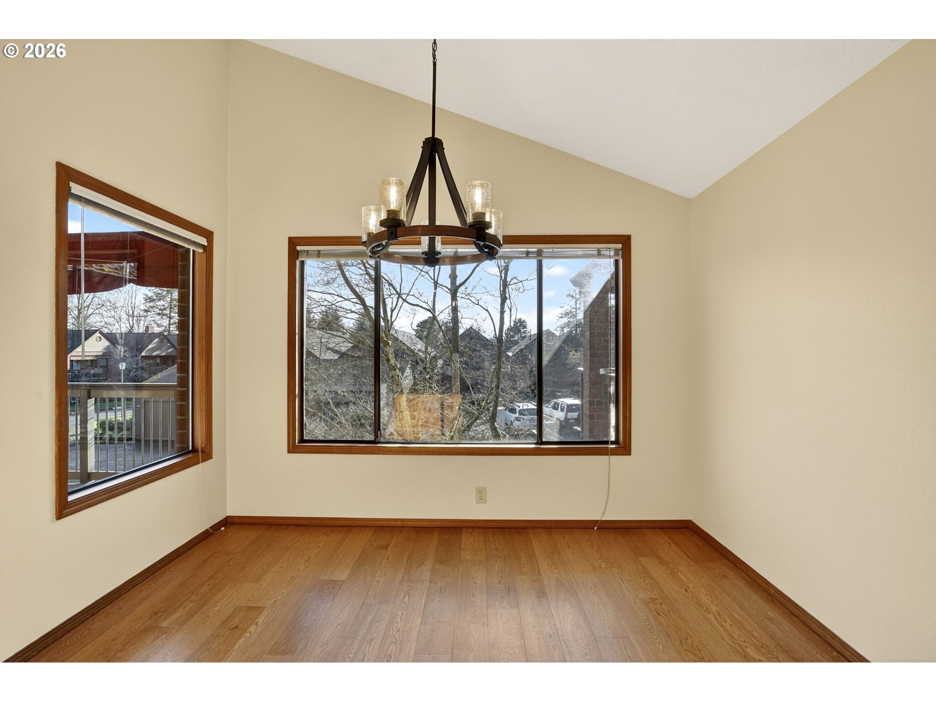 15485 Southwest 114th Court, Unit 39 Portland, OR 97224 - Photo 6 of 32 a view of an empty room with wooden floor and a window