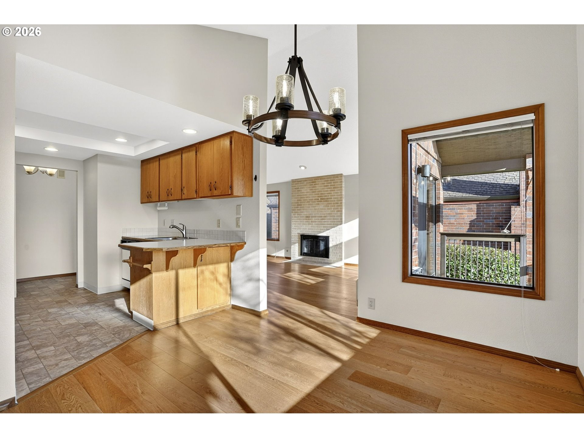 15485 Southwest 114th Court, Unit 39 Portland, OR 97224 - Photo 7 of 32 a kitchen with stainless steel appliances granite countertop a stove a sink and a wooden floors