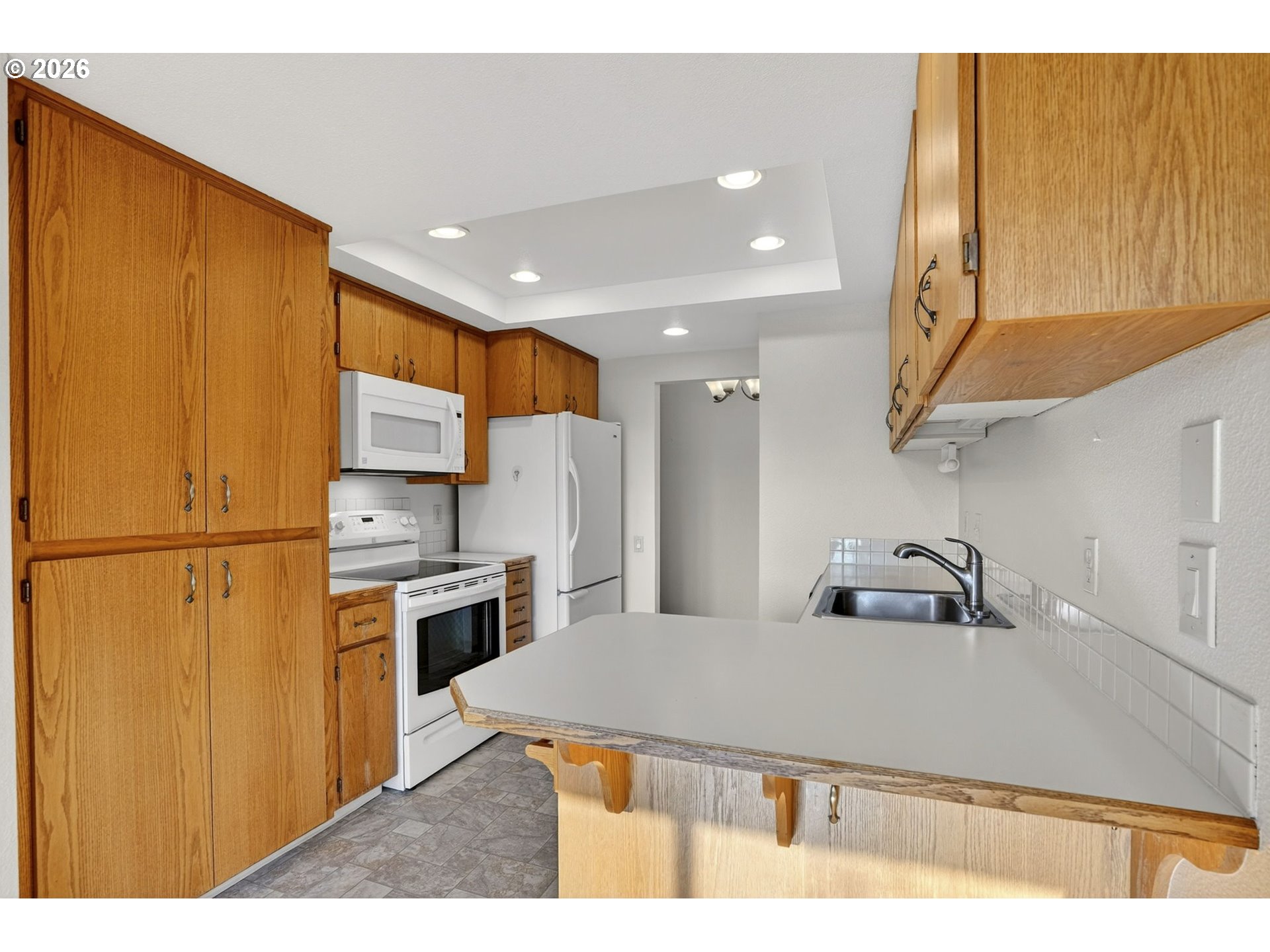 15485 Southwest 114th Court, Unit 39 Portland, OR 97224 - Photo 9 of 32 a kitchen with stainless steel appliances a refrigerator sink and stove