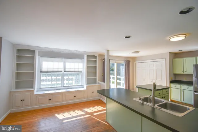 a large kitchen with granite countertop a sink and a window