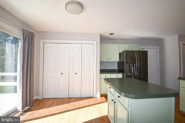 a kitchen with stainless steel appliances granite countertop a refrigerator a stove and a sink with granite countertops