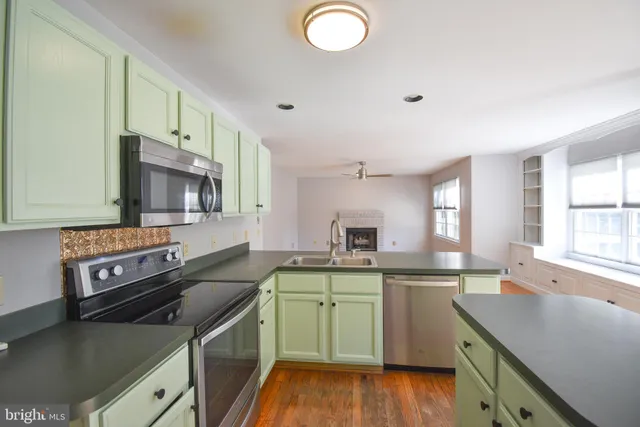 a kitchen with a sink stove and microwave