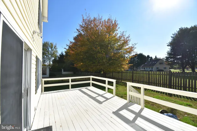 a view of balcony with wooden floor and fence