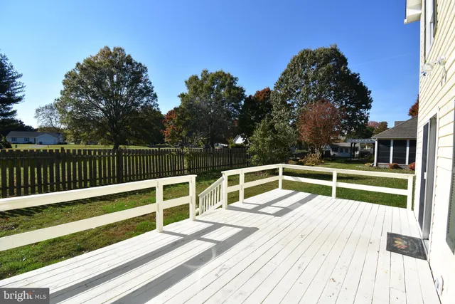 a view of wooden deck and a big yard