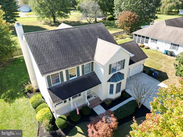 a aerial view of a house with a yard and balcony