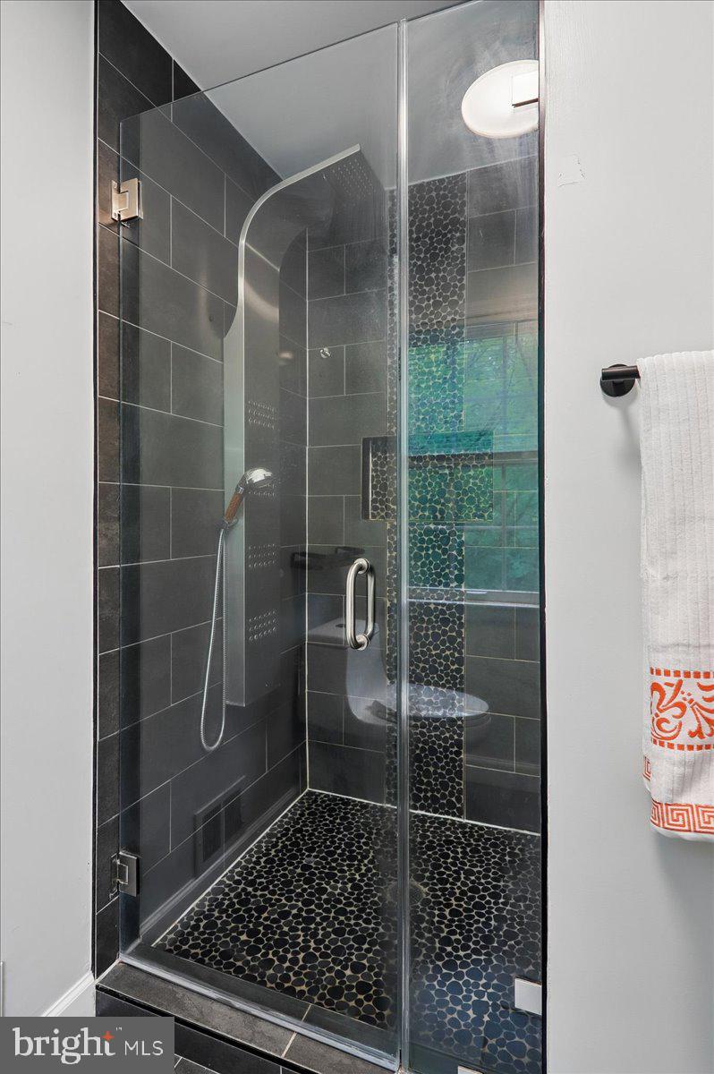 7408 Spring Tree Drive Springfield, VA 22153 - Photo 19 of 48 Sleek modern shower with elegant tiles.