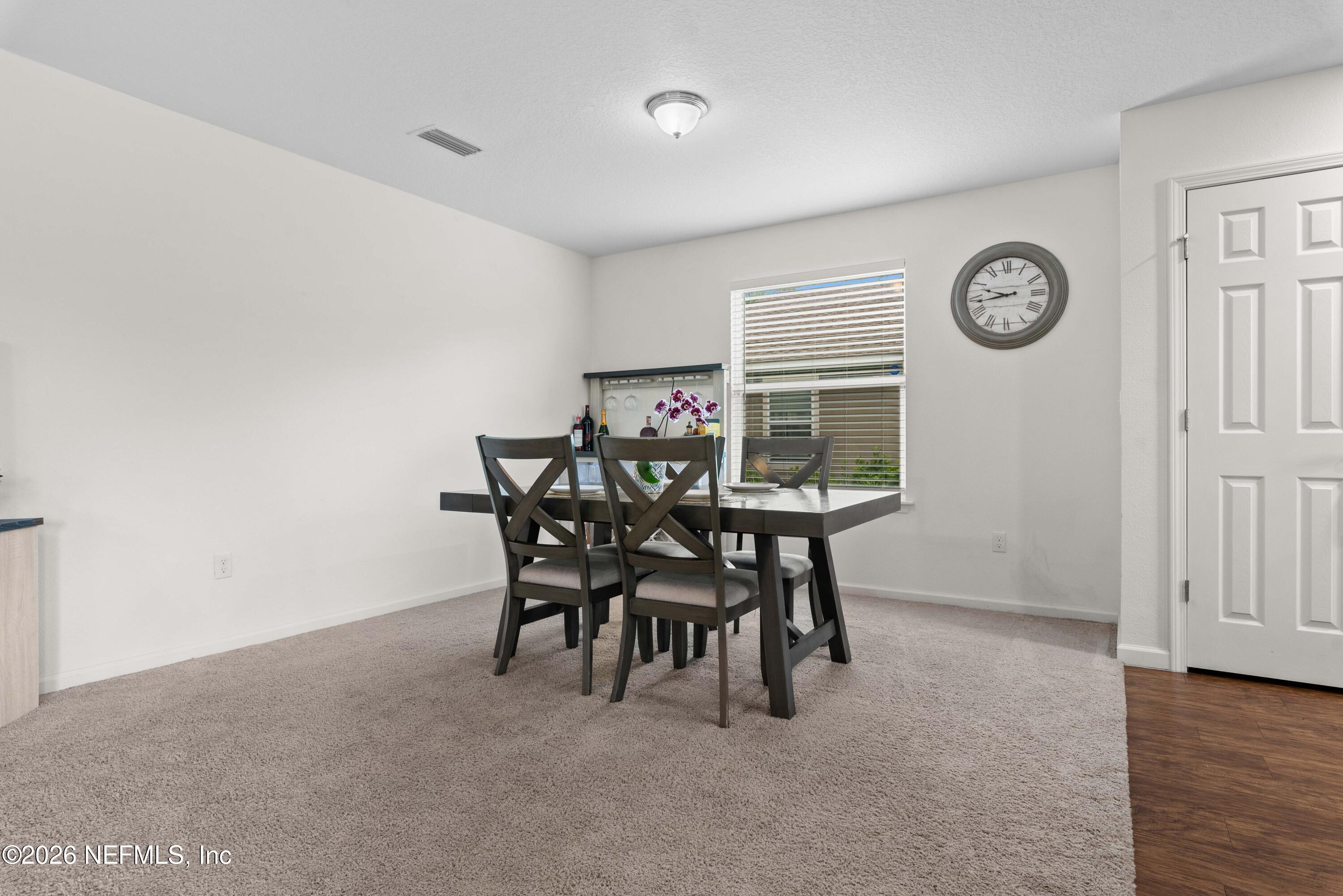 6178 Daylilly Road Macclenny, FL 32063 - Photo 10 of 29 a view of a dining room with furniture and a table