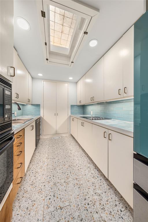 3020 North 43rd Street Waco, TX 76708 - Photo 11 of 40 a large kitchen with stainless steel appliances kitchen island granite countertop a sink a stove a counter space and cabinets