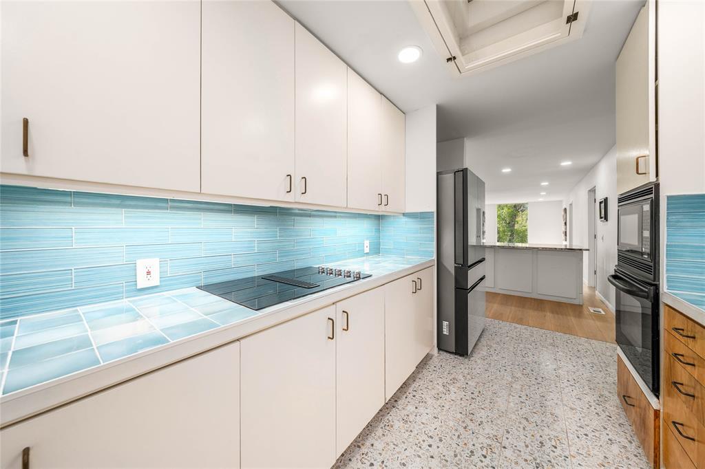 3020 North 43rd Street Waco, TX 76708 - Photo 14 of 40 a kitchen with stainless steel appliances granite countertop a sink and a stove