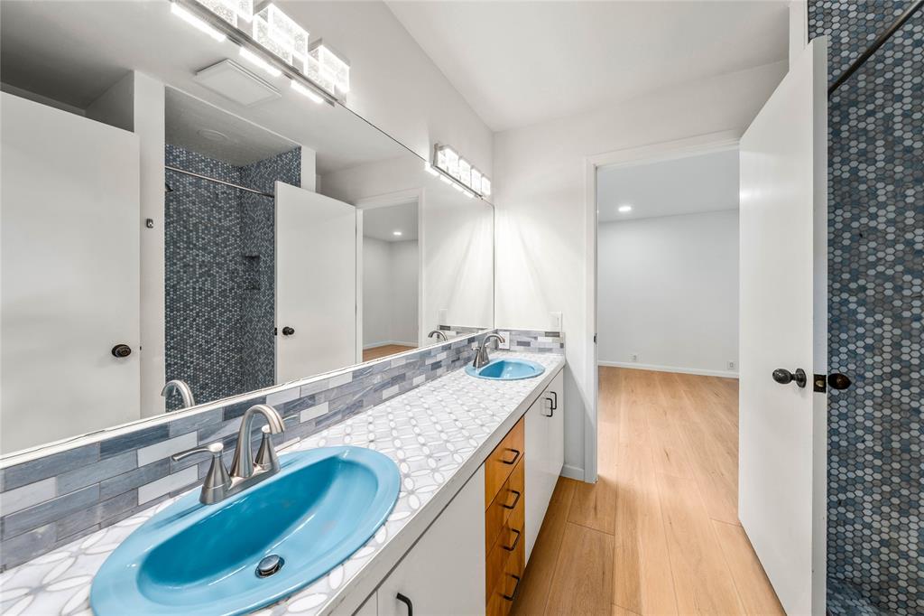 3020 North 43rd Street Waco, TX 76708 - Photo 28 of 40 a bathroom with a granite countertop double vanity sink and mirror