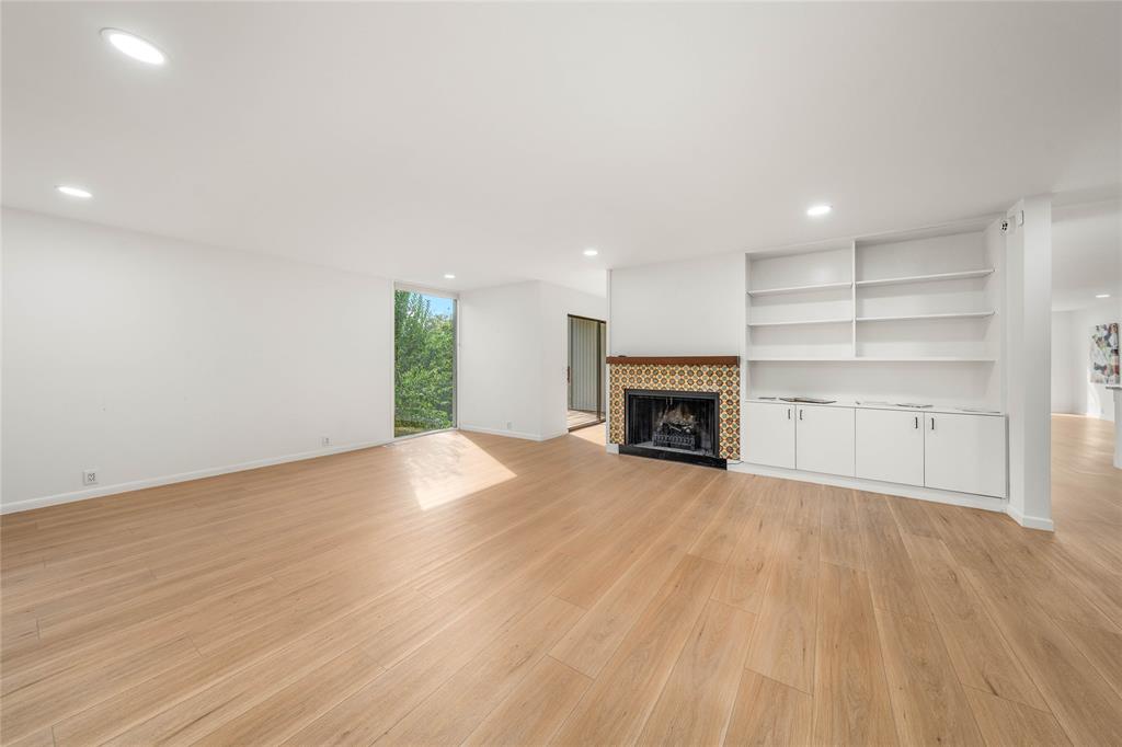 3020 North 43rd Street Waco, TX 76708 - Photo 7 of 40 a view of empty room with wooden floor and fireplace