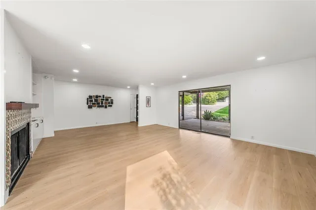 a view of an empty room with a fireplace