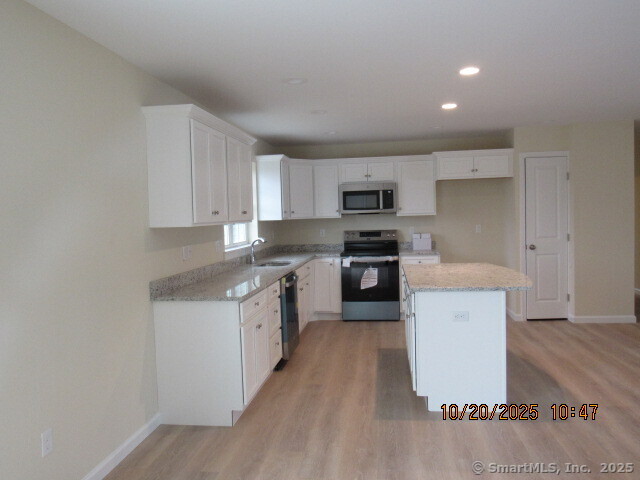 57 Warm Earth Road Naugatuck, CT 06770 - Photo 5 of 10 a kitchen with a sink a counter top space stainless steel appliances and cabinets