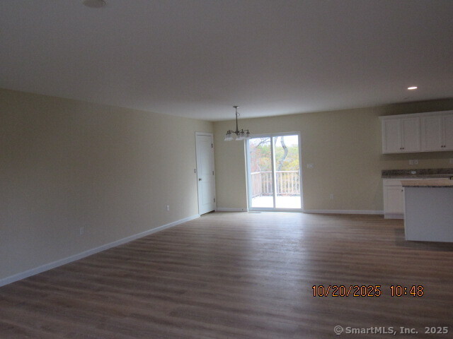 57 Warm Earth Road Naugatuck, CT 06770 - Photo 7 of 10 a view of an empty room with wooden floor and a window
