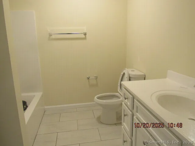 a white toilet sitting next to a bathroom sink