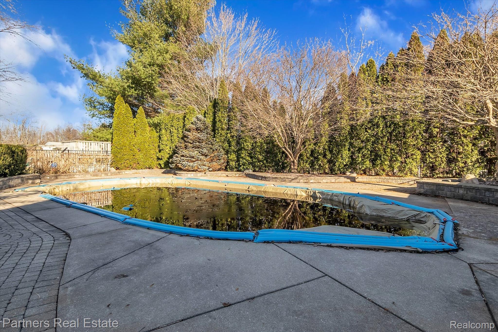 6400 Sharpe Road Fowlerville, MI 48836 - Photo 4 of 52 Inground Pool with beautiful landscape and patio surround.