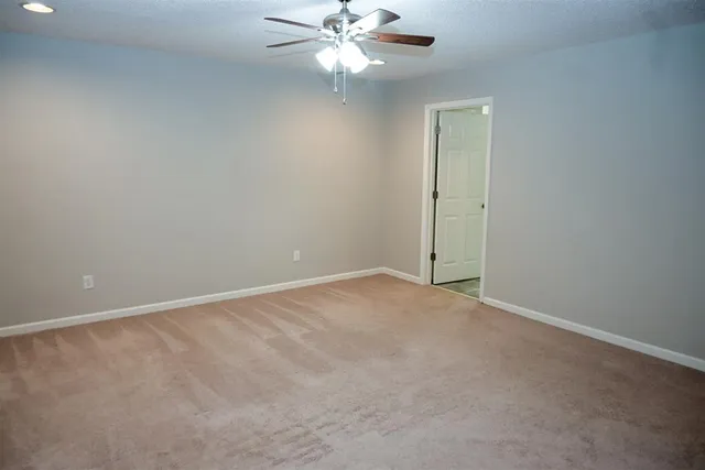 a bathroom with a granite countertop sink a mirror and a bathtub