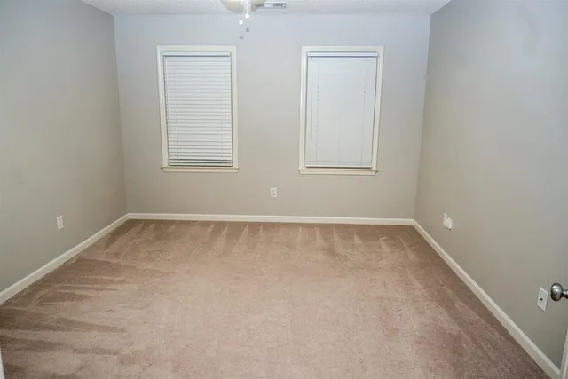 a view of hallway with a fireplace and a rug