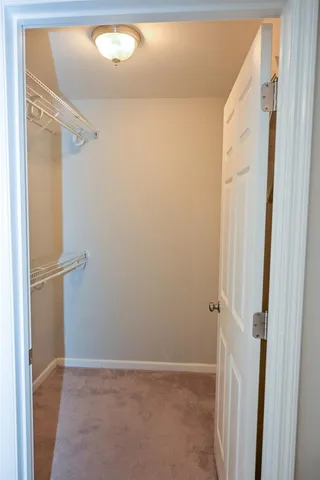 a bathroom with a granite countertop toilet sink and mirror