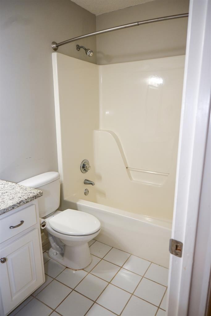 4847 Champion's Way Columbus, GA 31909 - Photo 30 of 39 a bathroom with a granite countertop sink toilet and shower