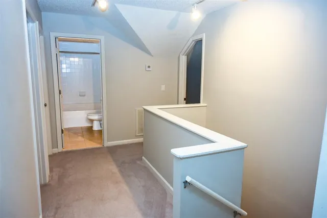 a bathroom with a granite countertop sink a toilet and bathtub
