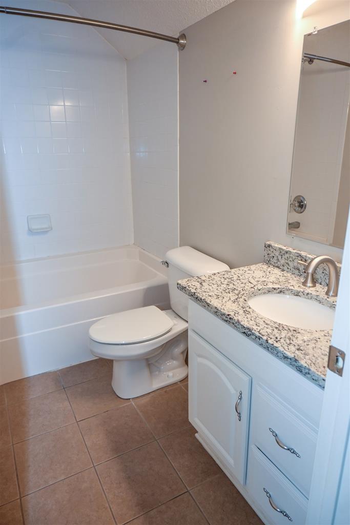 4847 Champion's Way Columbus, GA 31909 - Photo 35 of 39 a bathroom with a granite countertop sink a toilet and bathtub
