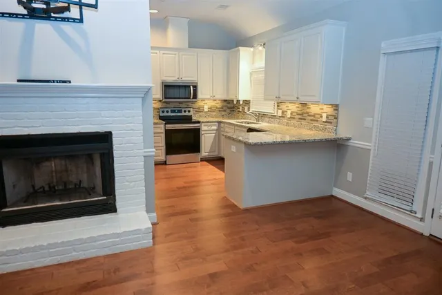 a kitchen with a sink stove and cabinets