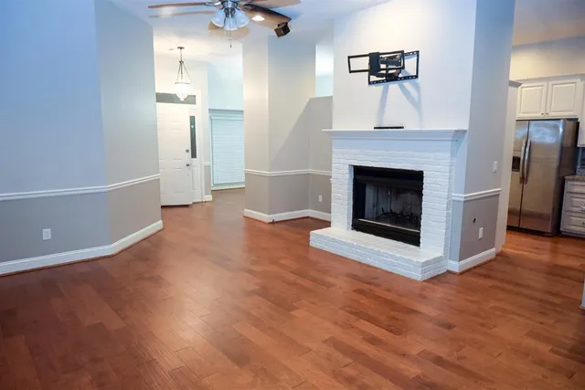 a view of a livingroom with an empty space and a fireplace