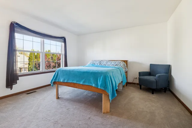 a bedroom with a bed and a couch