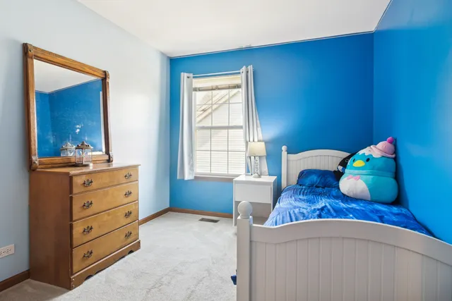 a bedroom with a bed and a dresser