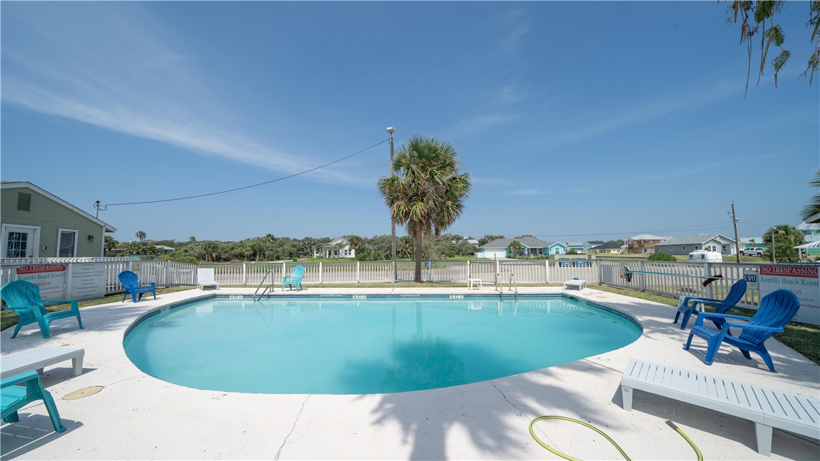2290 North Fulton Beach Road Rockport, TX 78382 - Photo 3 of 26 a view of a swimming pool and lounge chair