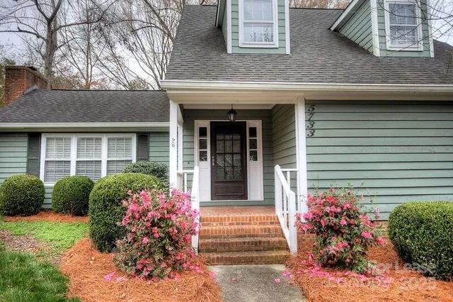 a view of a house with potted plants