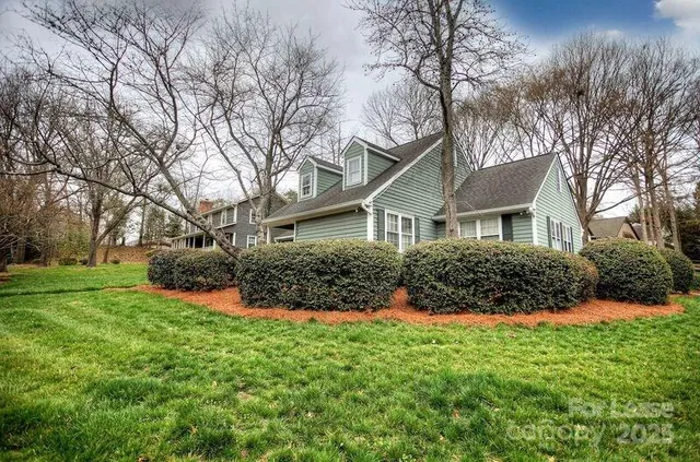 a front view of house with yard and green space