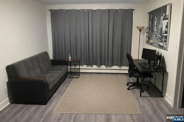 a living room with couches and furniture with wooden floor