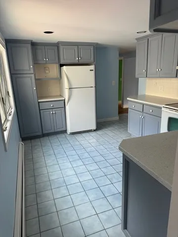 a kitchen with a sink a stove a refrigerator and cabinets