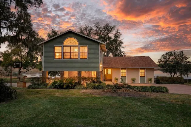 a front view of house with yard and green space