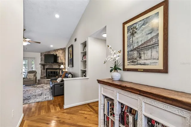 a living room with furniture and a floor to ceiling window