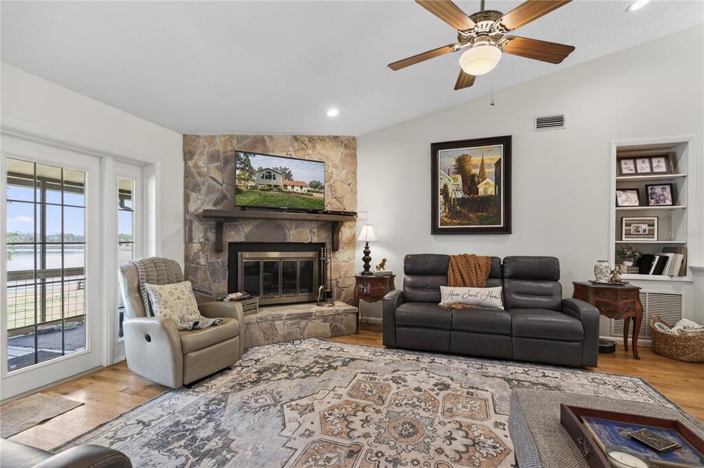 17025 Peru Road Umatilla, FL 32784 - Photo 13 of 73 a living room with furniture a flat screen tv and a fireplace